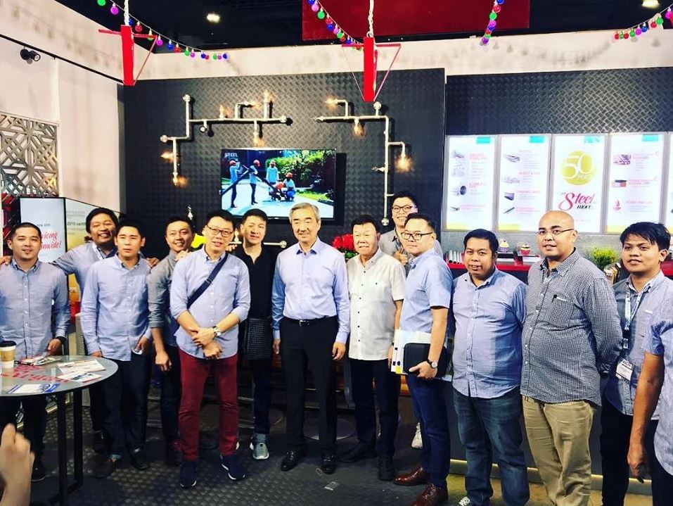 Group photographed inside the Supreme and Regan exhibition booth