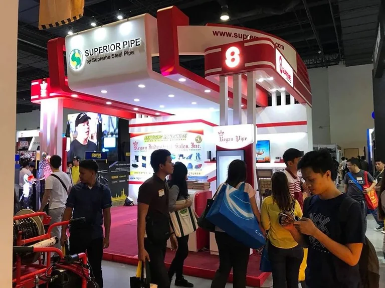 Supreme, Superior Pipe and Regan exhibition booth with people