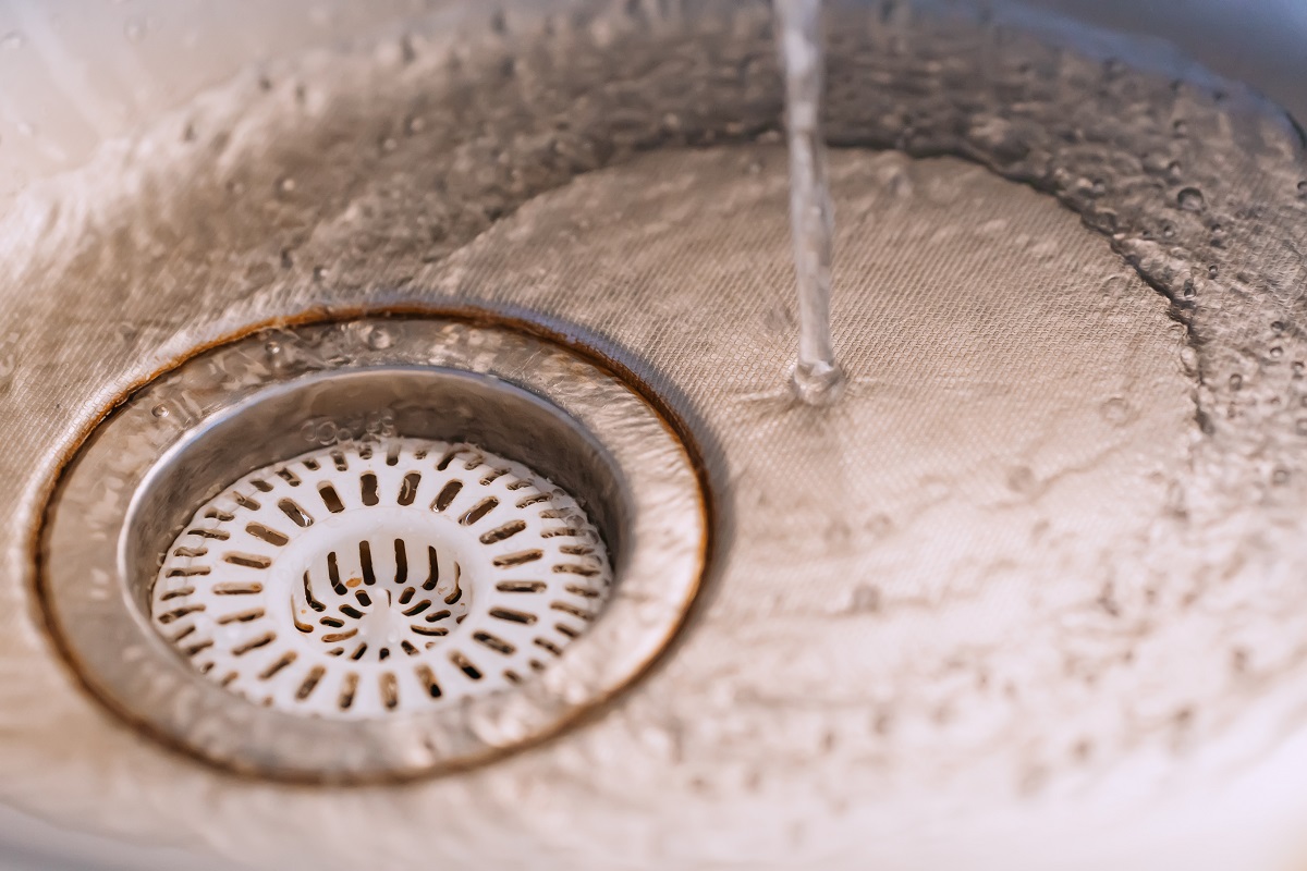 Kitchen sink with water. Background. Water splashes down. Concep