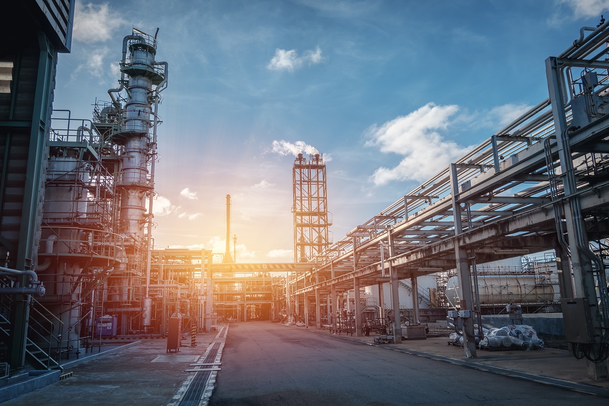 Pipeline and pipe rack of petroleum industrial plant with sunset sky background