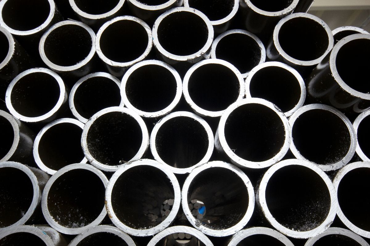 Close-up of stacked round metal pipes for construction and fabrication