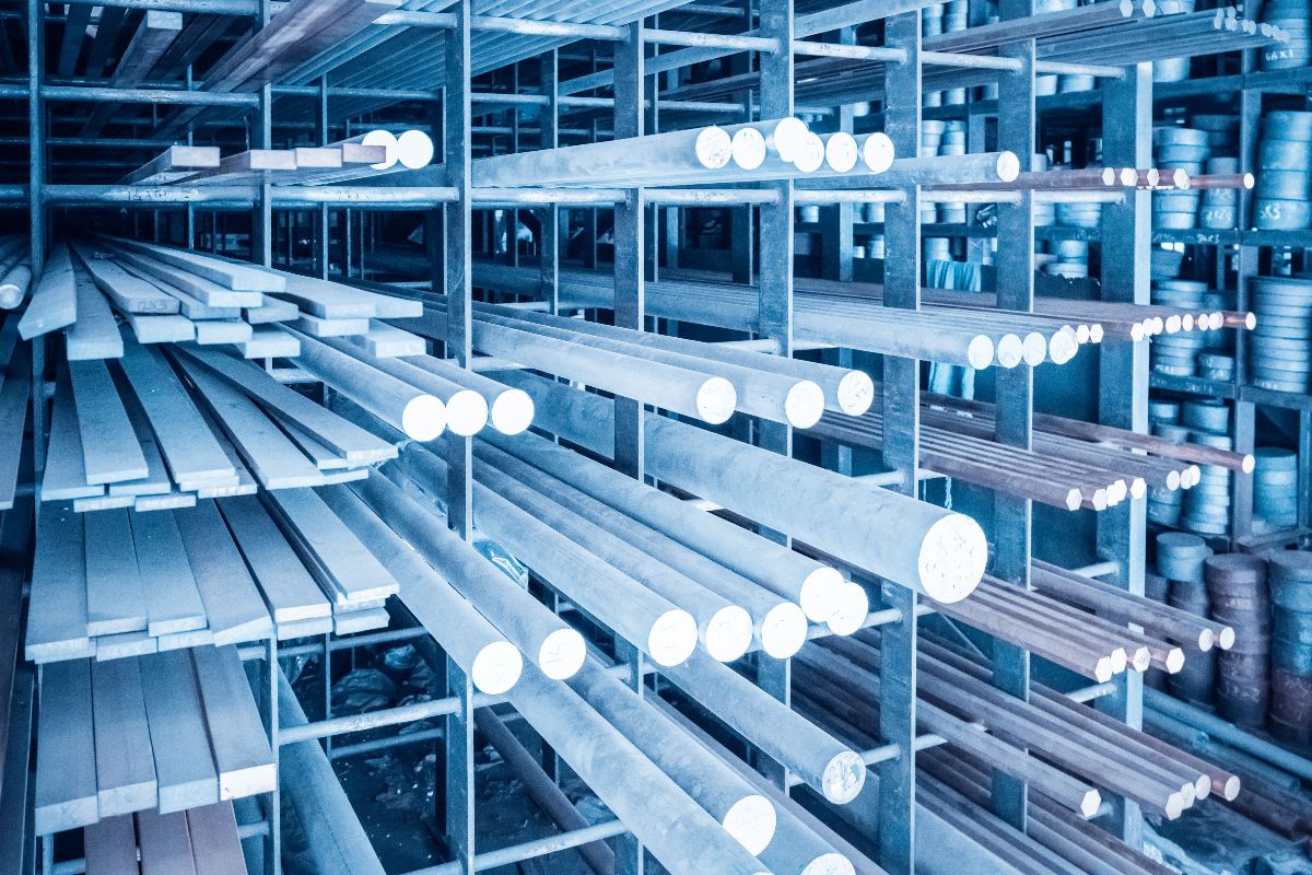 Steel bars and pipes stored on industrial warehouse racks