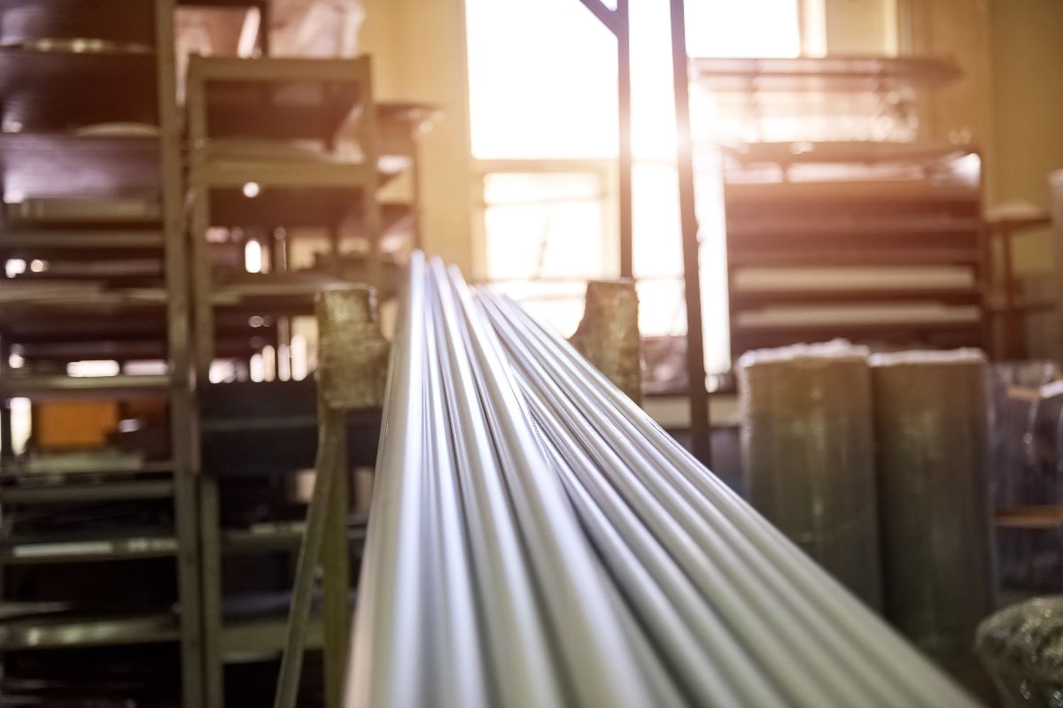 Close-up of long water pipes arranged inside a warehouse