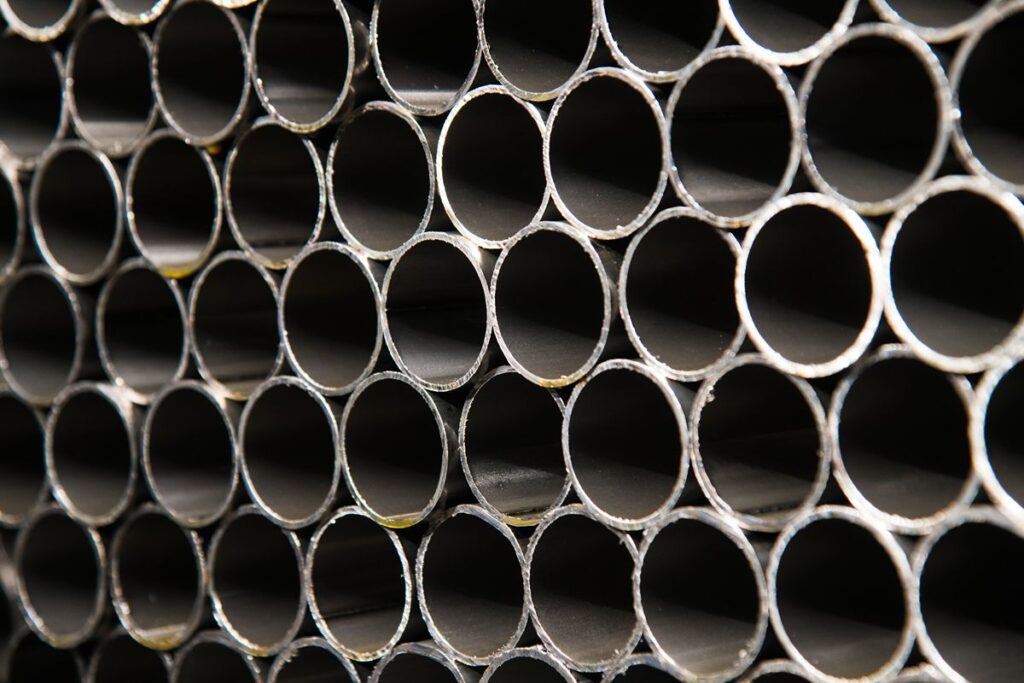 Close-up of stacked steel pipe openings illustrating pipe condition and internal flow capacity considerations