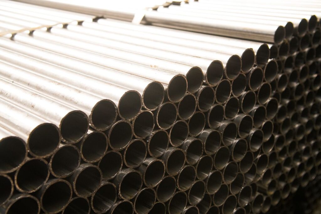 Stacked steel pipes showing uniform round openings and durable construction for drainage applications
