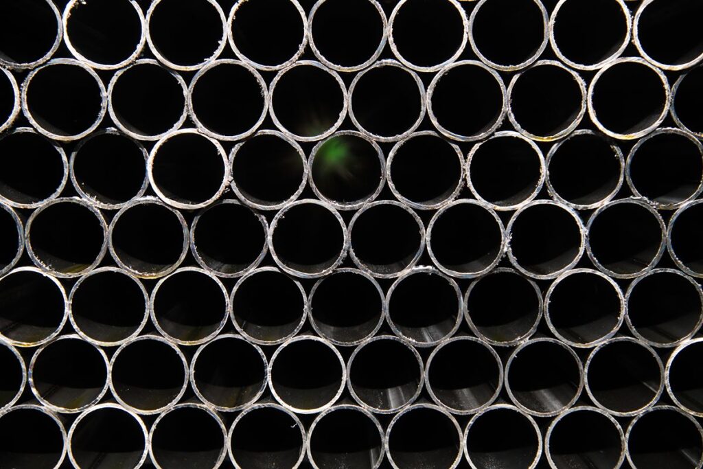 Close-up of stacked steel pipe openings showing uniform diameter and condition for quality inspection