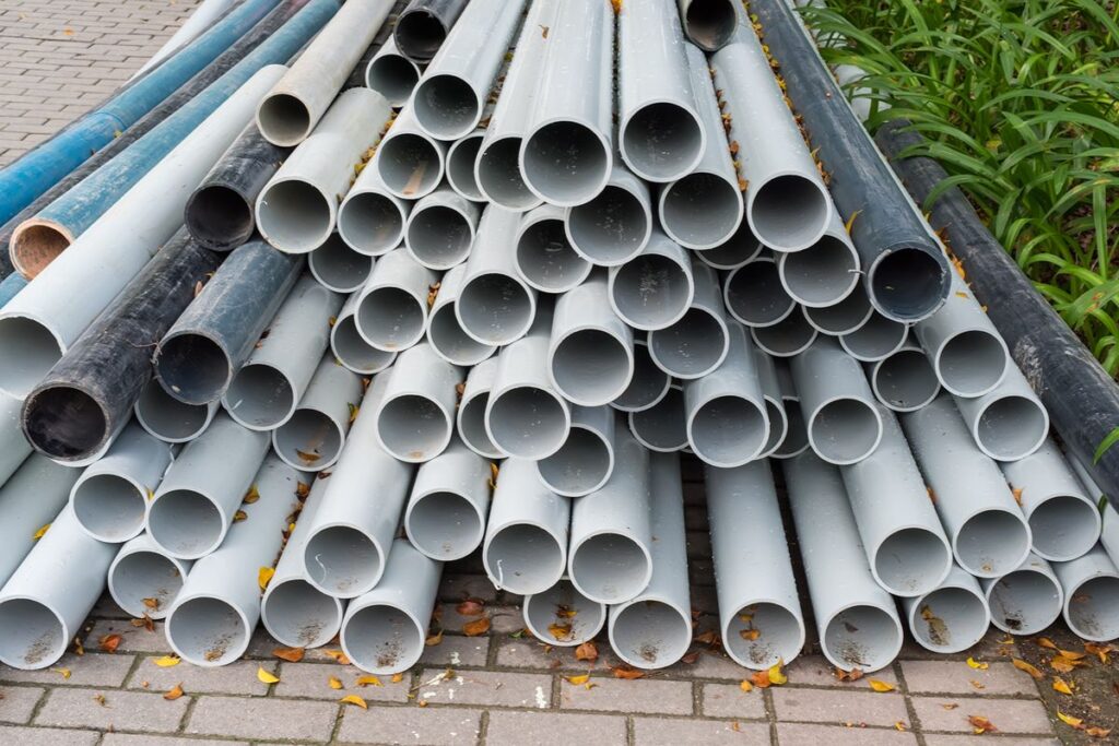 Stacked heavy gauge steel pipes prepared for structural support and construction applications