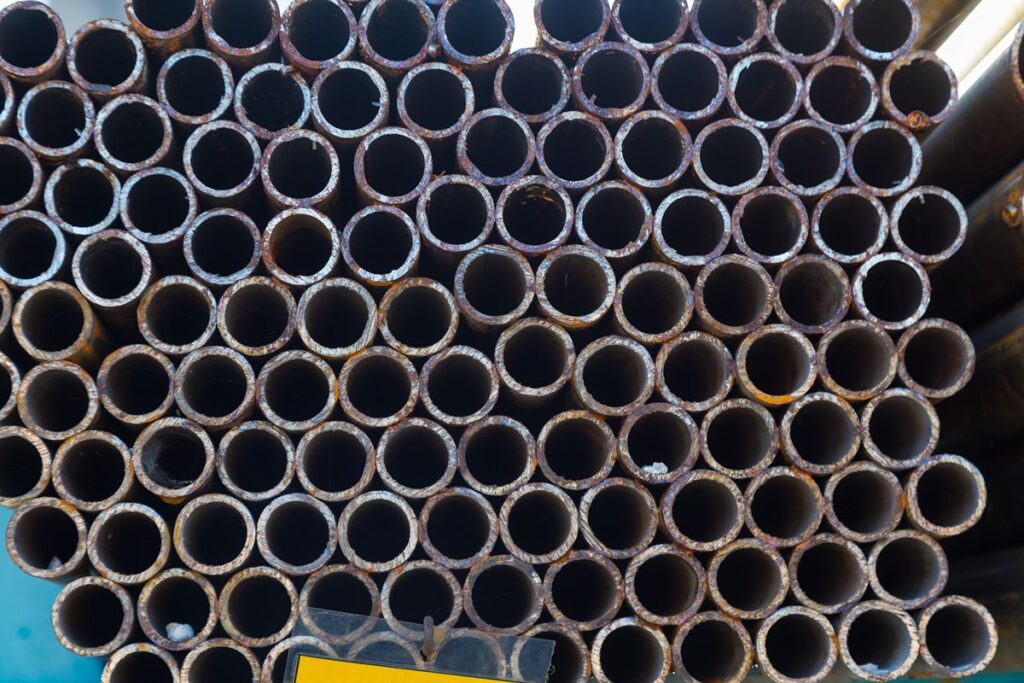 Close-up of stacked steel pipe openings showing product uniformity and condition for supplier quality evaluation.